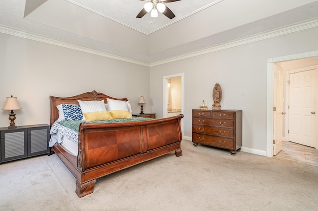 carpeted bedroom featuring baseboards, a raised ceiling, ornamental molding, and a ceiling fan