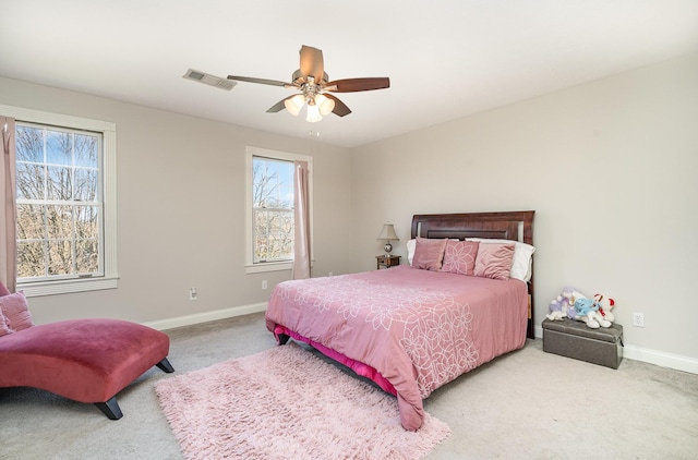 carpeted bedroom featuring baseboards, visible vents, and ceiling fan