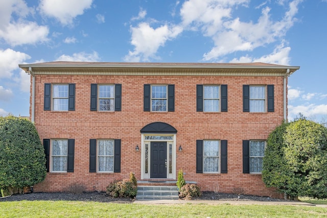 colonial-style house with brick siding