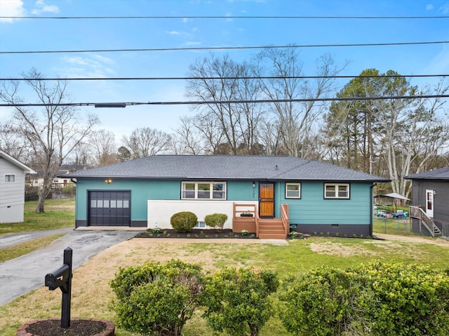 view of front of property with a front yard, roof with shingles, driveway, a garage, and crawl space