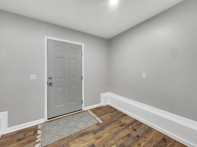 foyer entrance with baseboards and wood finished floors