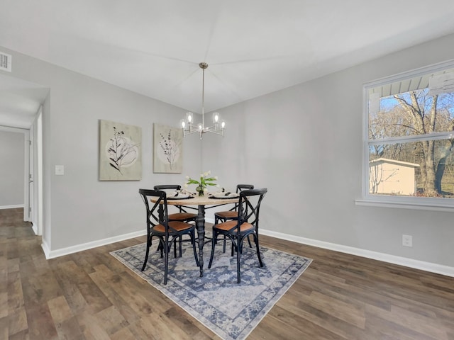 dining space featuring wood finished floors and baseboards