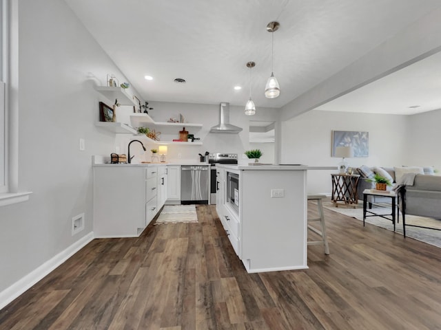 kitchen with open shelves, appliances with stainless steel finishes, wall chimney exhaust hood, and dark wood finished floors