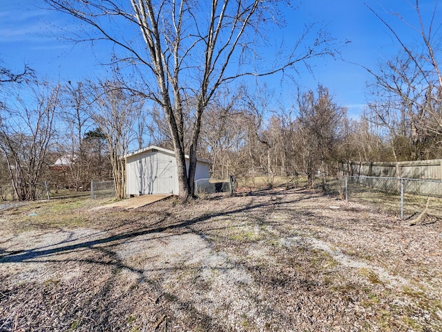 view of yard featuring a storage shed, fence, and an outdoor structure