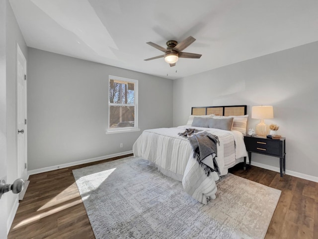 bedroom with ceiling fan, baseboards, and wood finished floors