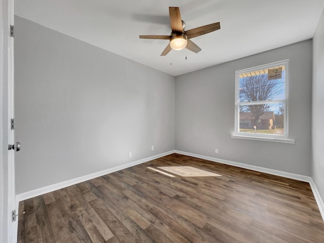 unfurnished room featuring ceiling fan, baseboards, and wood finished floors