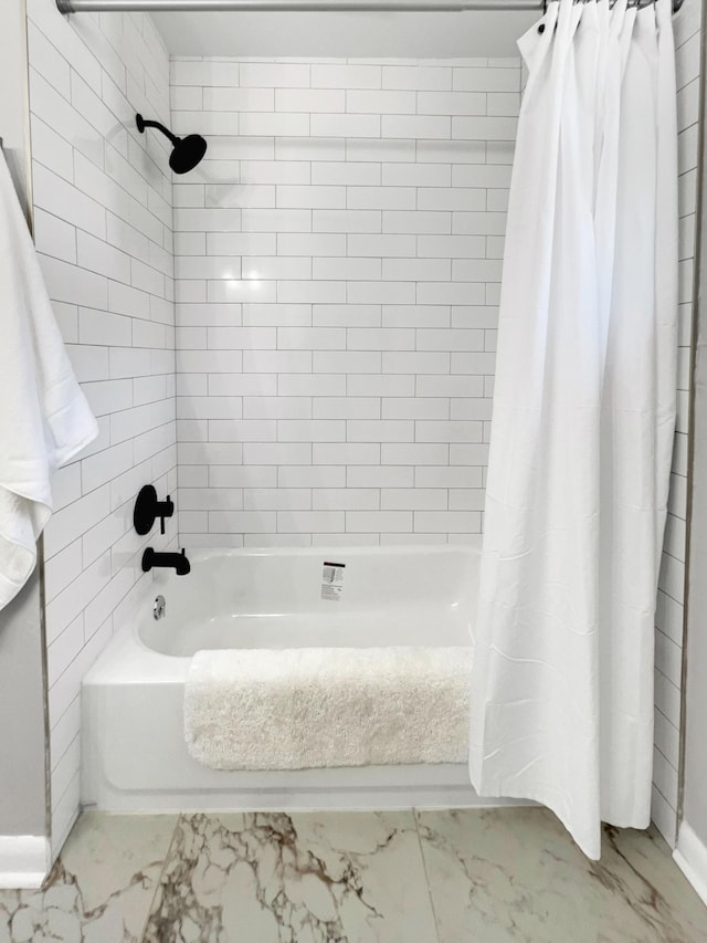 full bathroom featuring marble finish floor and shower / tub combo