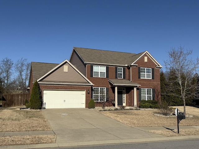 view of front of house featuring brick siding, an attached garage, concrete driveway, and fence