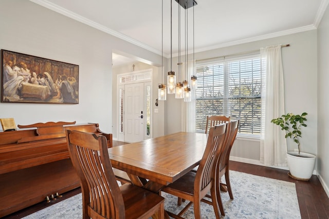 dining room featuring dark wood finished floors, baseboards, and ornamental molding