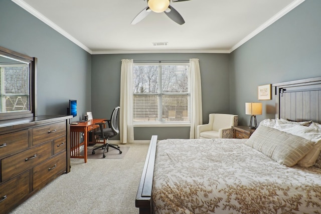 bedroom with visible vents, light colored carpet, crown molding, and ceiling fan