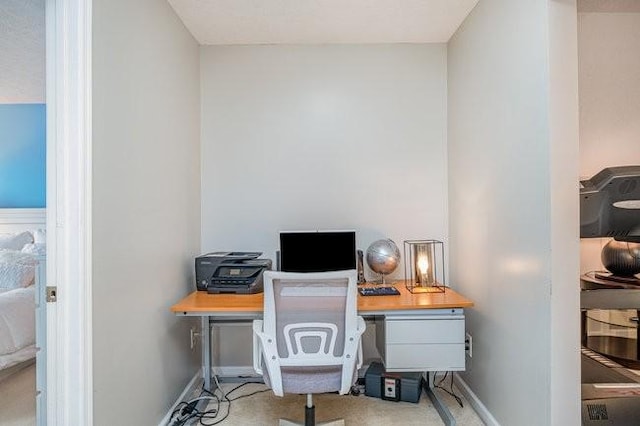 office space with baseboards and carpet flooring