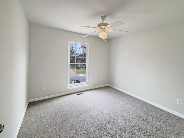 unfurnished room featuring visible vents, baseboards, a ceiling fan, and carpet flooring