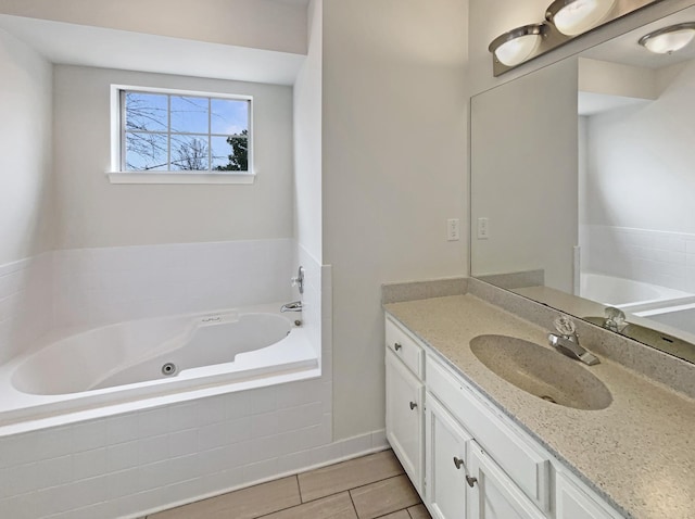 bathroom with vanity and a tub with jets