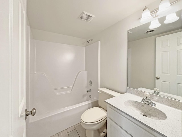 bathroom featuring vanity, toilet, wood finished floors, and visible vents