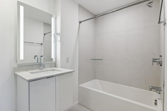 bathroom featuring washtub / shower combination and vanity