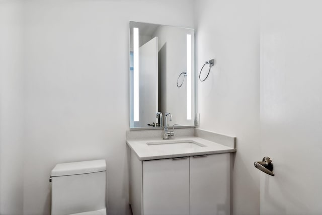 bathroom featuring toilet and vanity