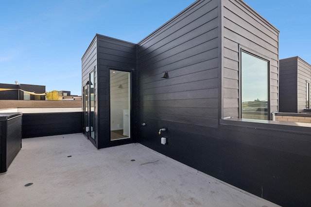 view of side of home with a patio area