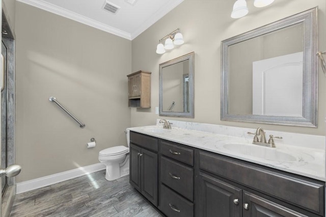 full bathroom featuring a sink, visible vents, toilet, and ornamental molding