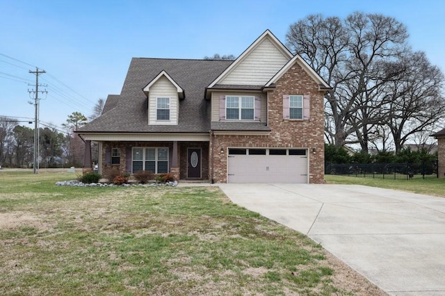 craftsman-style house featuring a garage, driveway, brick siding, and a front lawn