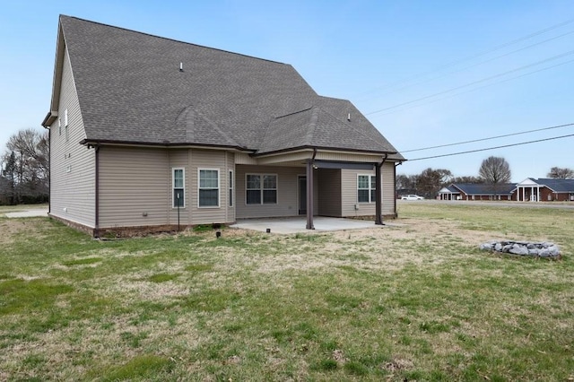 back of house featuring a yard, a patio area, and roof with shingles