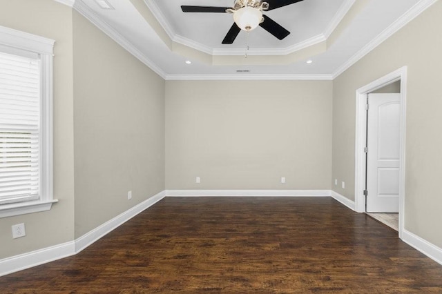 unfurnished room with wood finished floors, baseboards, a tray ceiling, ceiling fan, and ornamental molding