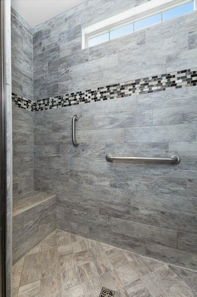 bathroom featuring a wealth of natural light and a tile shower