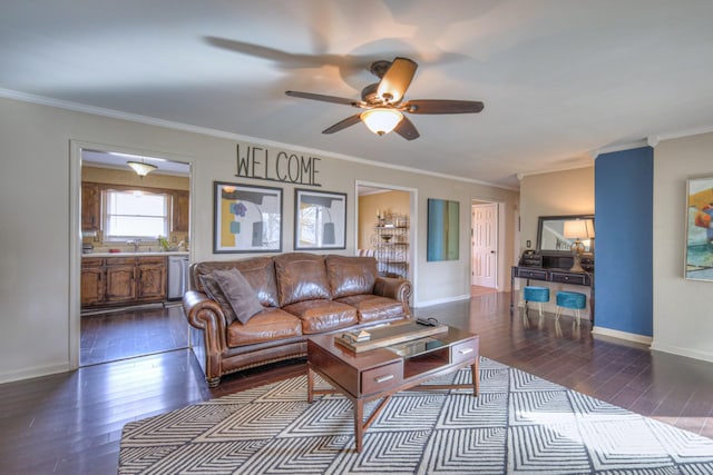 living room with baseboards, dark wood-style flooring, and crown molding