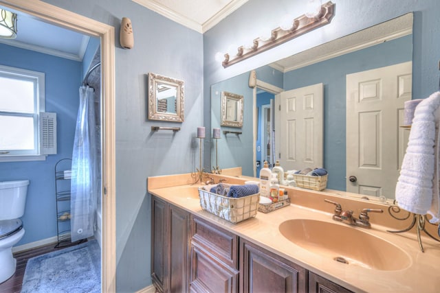 full bathroom featuring a shower with shower curtain, double vanity, ornamental molding, a sink, and toilet