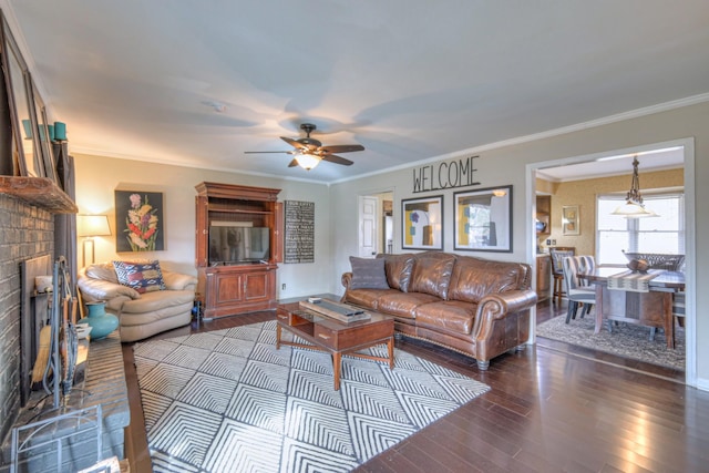 living area featuring a brick fireplace, wood finished floors, and ornamental molding