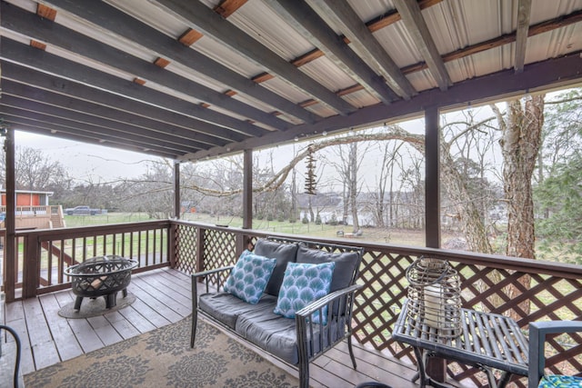 deck with an outdoor living space with a fire pit