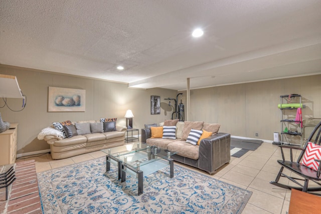 living area featuring light tile patterned floors, baseboards, a textured ceiling, and recessed lighting