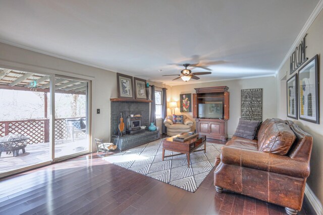 living room with a ceiling fan, crown molding, and wood finished floors