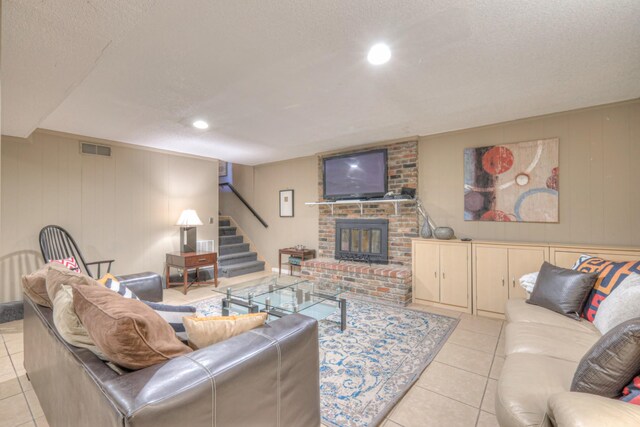 living area featuring visible vents, a brick fireplace, stairway, light tile patterned floors, and recessed lighting