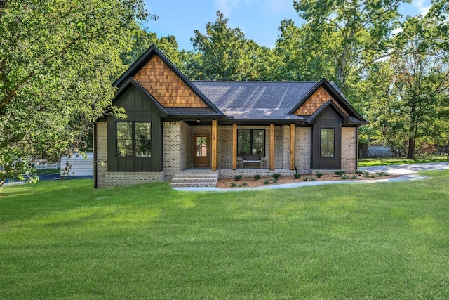 craftsman house with brick siding, board and batten siding, and a front yard