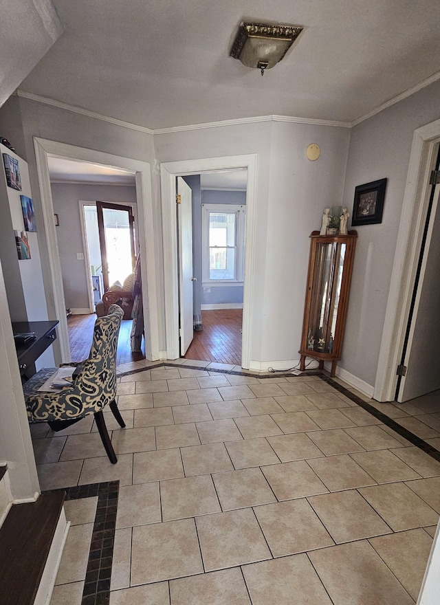 corridor with baseboards, ornamental molding, and light tile patterned flooring