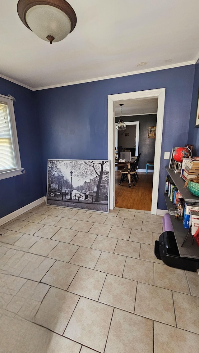 unfurnished room featuring tile patterned flooring, baseboards, and ornamental molding