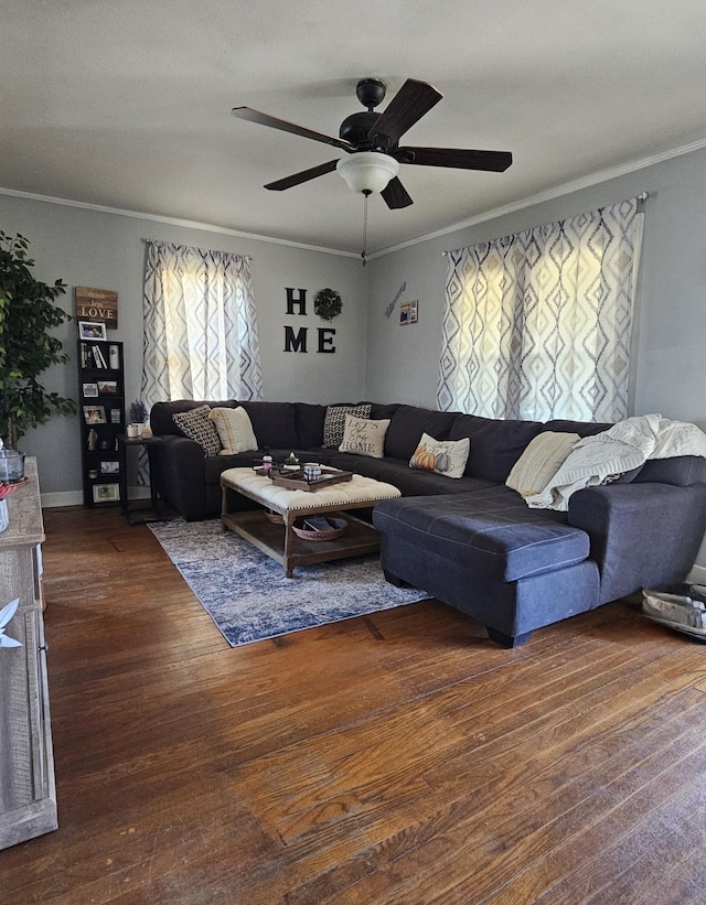 living area with wood finished floors, ornamental molding, and a ceiling fan