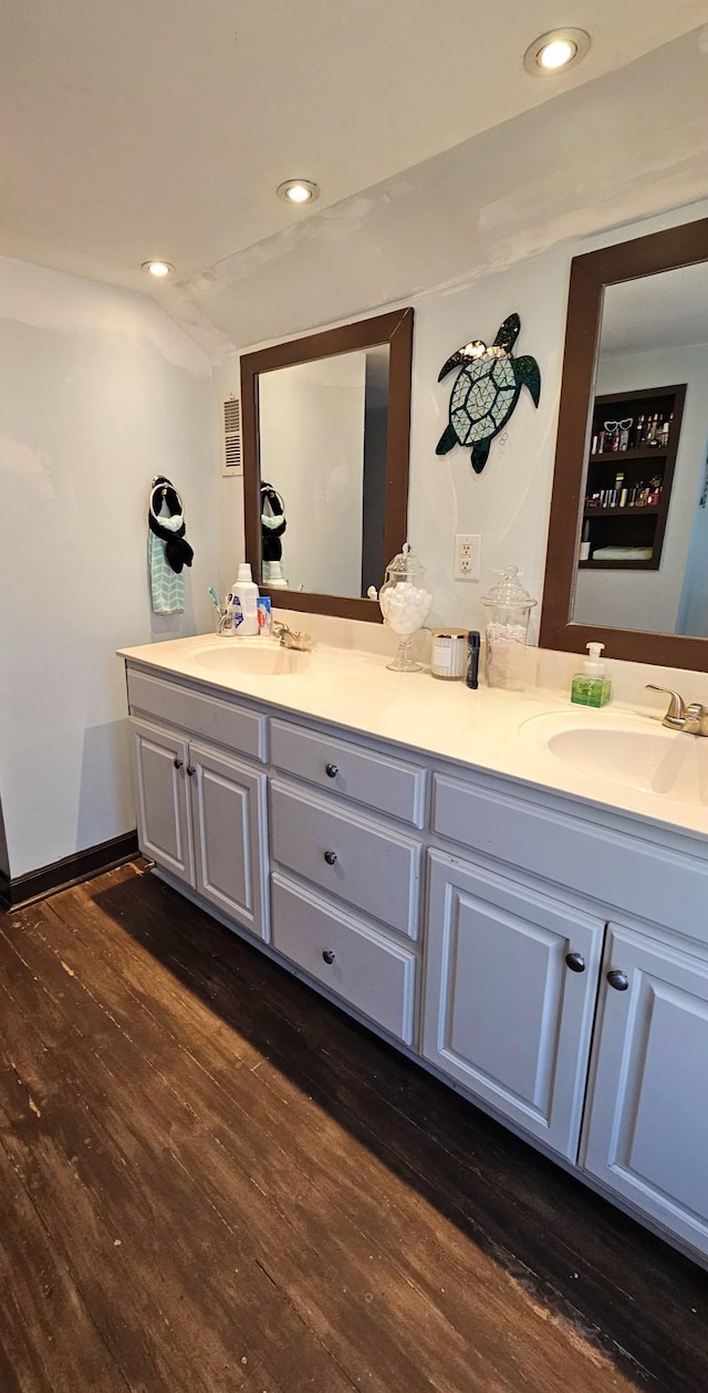 full bathroom featuring a sink, wood finished floors, and double vanity