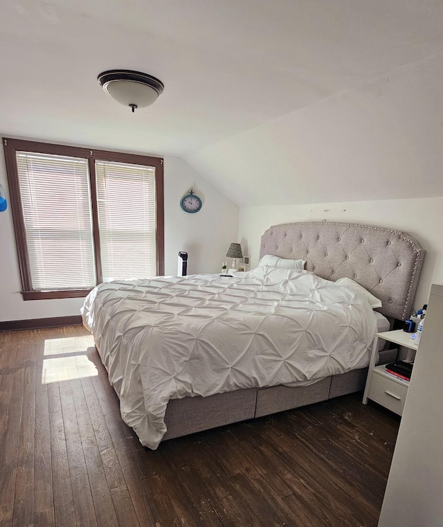 bedroom featuring lofted ceiling and hardwood / wood-style floors