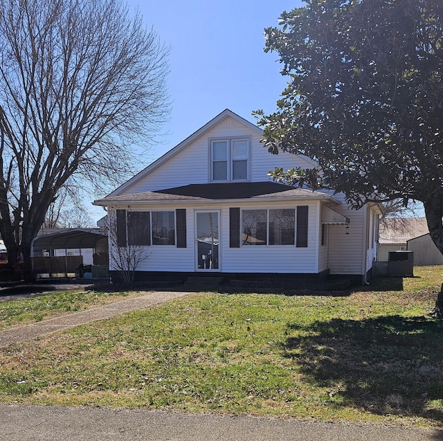 bungalow-style house with a detached carport and a front yard