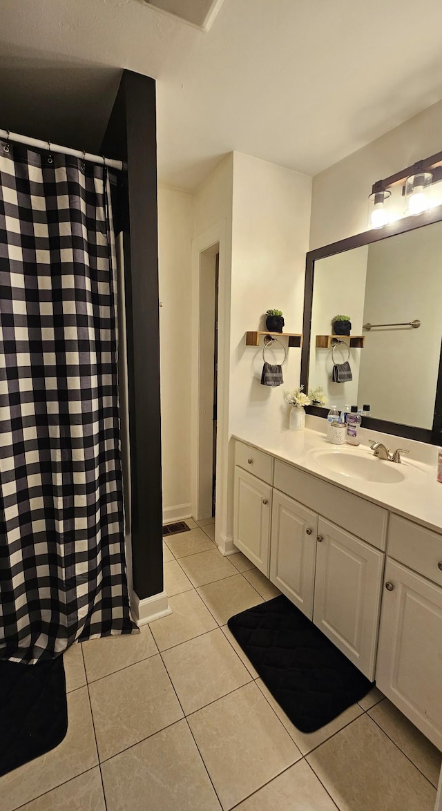 full bath with tile patterned floors, vanity, and a shower with shower curtain