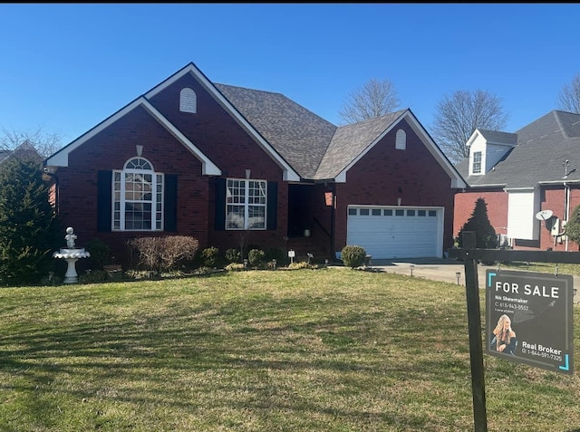 view of front facade featuring a garage, brick siding, concrete driveway, and a front yard