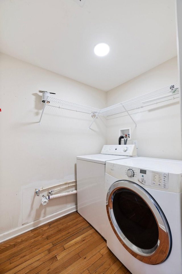 laundry area featuring laundry area, independent washer and dryer, and light wood-style flooring