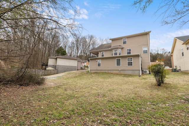 rear view of house featuring a lawn