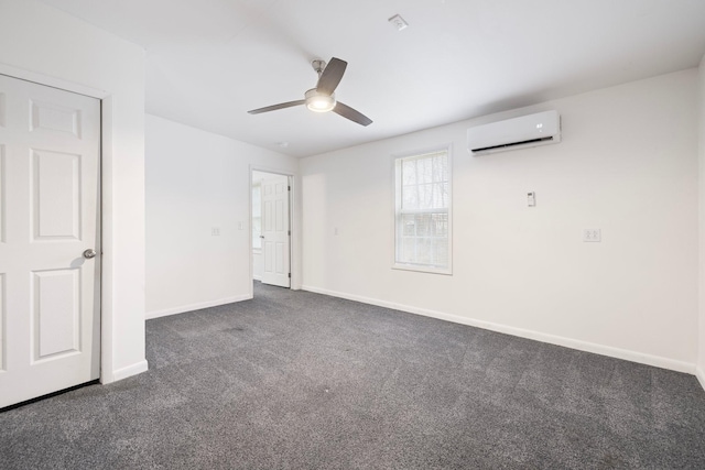 interior space with baseboards, carpet floors, ceiling fan, and a wall unit AC