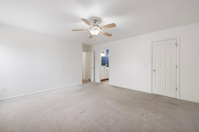 empty room with ceiling fan, baseboards, and light carpet