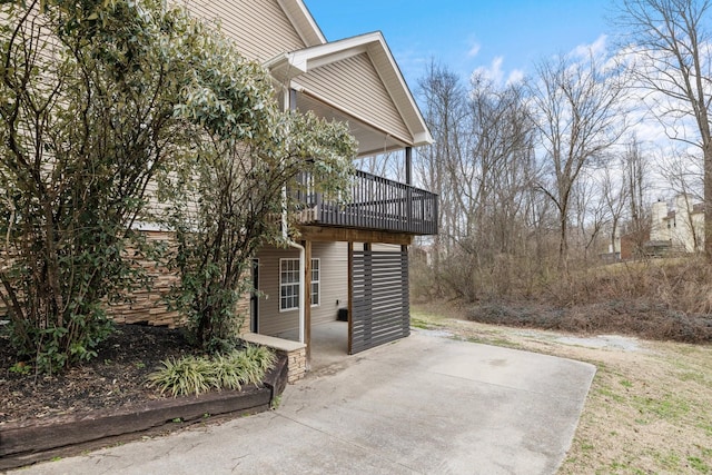 view of property exterior with a wooden deck