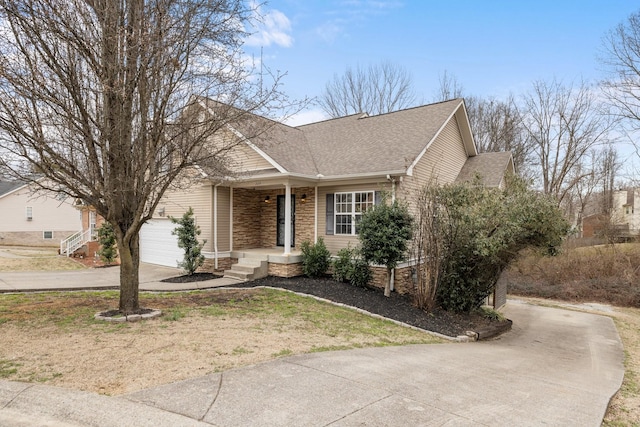 view of front of property with roof with shingles and concrete driveway