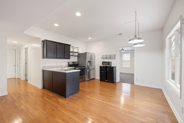 kitchen with visible vents, light wood finished floors, recessed lighting, appliances with stainless steel finishes, and light countertops