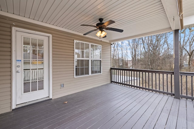 wooden deck with a ceiling fan